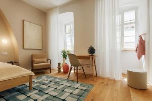 a bedroom with a bed and a desk and a chair at homie stay Dominikus in Würzburg