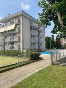 an apartment building with a tennis court in front of it at Z37 4bed, terrace, tennis and summer pool, 10 min Milan in Opera