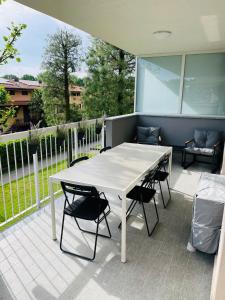 a white table and chairs on a patio at Z37 4bed, terrace, tennis and summer pool, 10 min Milan in Opera