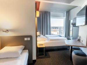 Postel nebo postele na pokoji v ubytování B&B HOTEL Aalborg