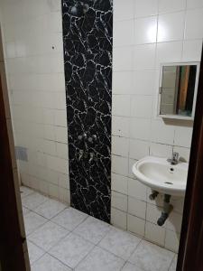 a bathroom with a sink and a mirror at Bright Beach Homestays in Calangute