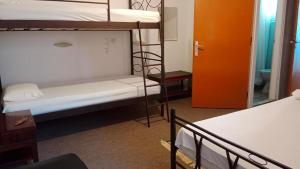 a room with two bunk beds and a door at Hotel Hermes in Olympia