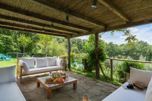 a patio with a white couch and a table at Villa Vesta by My Villa Collection in San Casciano dei Bagni