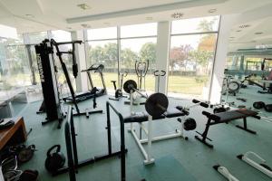 a gym with several treadmills and machines in a room at Villa Horizon-Siófok in Siófok