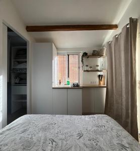 a bedroom with a bed and a window at Maisonnette cosy à la campagne in Céret +14 photos