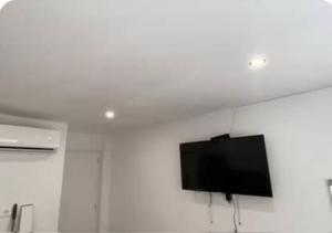 a flat screen tv hanging on a white wall at alojamiento near everything in Valencia