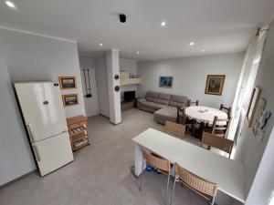 a kitchen and living room with a couch and a table at Lago Cimino in Ronciglione