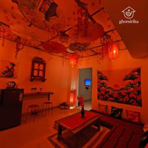 a living room with a table and a painting on the ceiling at Natsukashii by Ghorsirika in Guwahati
