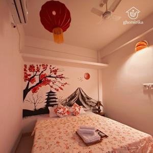 a bedroom with a bed with a tree mural on the wall at Natsukashii by Ghorsirika in Guwahati