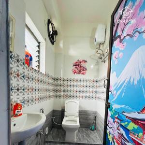 a bathroom with a toilet and a sink at Natsukashii by Ghorsirika in Guwahati