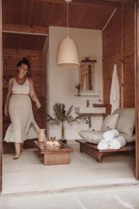 a woman is standing in a living room at Maniero Montecassiano in Montecassiano