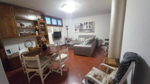 a living room with a table and a couch at L'Ulivo, alloggio in seminterrato in Fornello