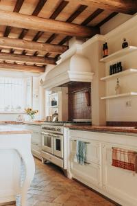 a kitchen with white appliances and a wooden ceiling at Maniero Montecassiano in Montecassiano