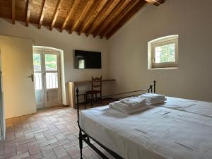 a bedroom with a bed and a table and a window at Antico Mulino Boutique House in Garda