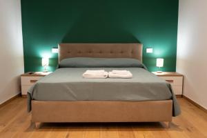 a bedroom with a bed with two towels on it at G&G Luxury Rooms in Bari