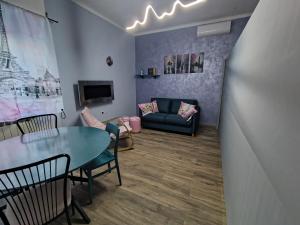 a living room with a table and a couch at L'angolo del Viaggiatore 5 Terre in La Spezia