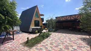 a house with a brick patio and a building at Art House in Yerevan +19 photos
