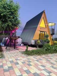 a small house with a black and yellow roof at Art House in Yerevan