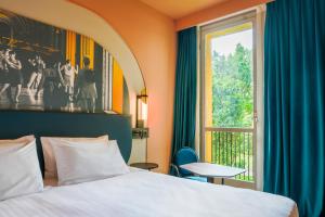 a hotel room with a bed and a window at Mercure Bologna Centro in Bologna +220 photos