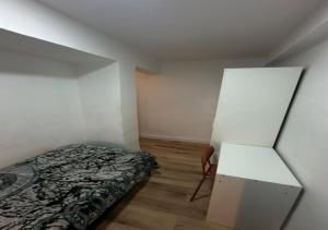 a small bedroom with a bed and a cabinet at alojamiento near everything in Valencia
