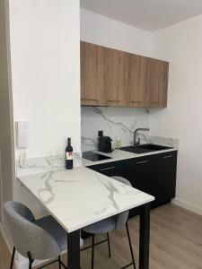 a kitchen with a table and two chairs and a sink at Appartement hyper-centre Rodez in Rodez