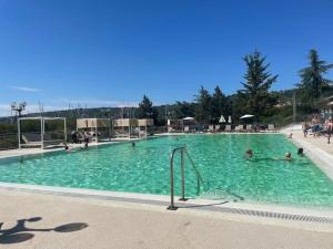 a large swimming pool with people in the water at Floating Sea House - 5Stars in Portorož