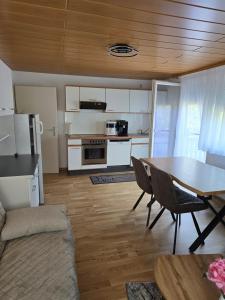 a living room with a table and a kitchen at Hirsch Panorama in Bad Wildbad