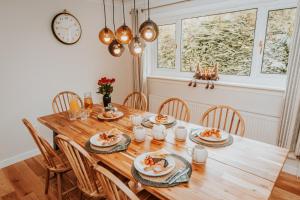 a dining room with a wooden table and chairs at Maisy's Hideaway in Kyleakin