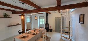 a dining room with a table and a ladder at Fuglsang Langeland in Tranekær +47 photos