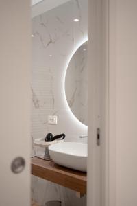 a bathroom with a white sink and a mirror at G&G Luxury Rooms in Bari