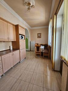 a kitchen with a table and chairs in a room at Rijkov St Apartment in Gyumri +14 photos