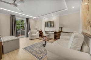 a living room with a couch and a table at ChiemseeStern Vacation & Recreation "Adults Only" in Gstadt am Chiemsee