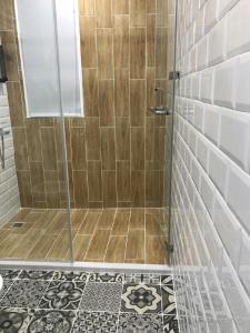 a shower with a glass door in a bathroom at 廷海特潮流民宿 漢中館 民宿編號1746 寵物友善陽台房 近微光集與鐵道藝術村 in Taitung City