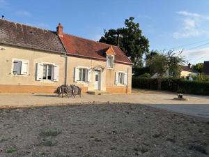 two horses are standing outside of a house at Gite des trois vergers in Sidiailles