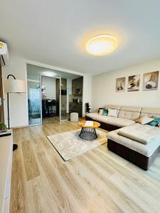 a living room with a couch and a table at Evoli Apartman in Debrecen