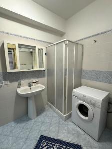 a bathroom with a washing machine and a sink at Oasi di Tindari in Oliveri