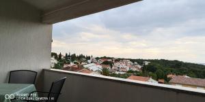 a view of a city from a balcony at Green Sea View Apartment in Premantura