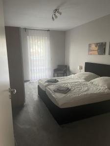 a bedroom with a large bed and a window at Ferienhaus am Ruppiner See in Neuruppin