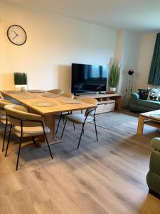 a living room with a table and chairs and a tv at Apartmán Mateřídouška in Cerny Dul +4 photos