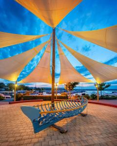 a group of chairs with umbrellas on a patio at Apartment M&M Klimno in Klimno