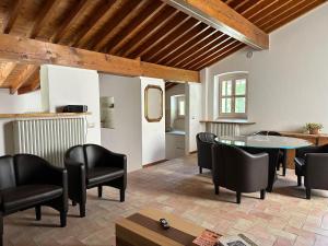 a living room with black chairs and a table at Antico Mulino Boutique House in Garda