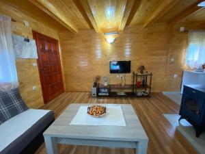 a living room with a coffee table and a tv at Happy Hikers in Kovačka Dolina