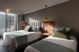 Postel nebo postele na pokoji v ubytování OZ Hotel Collection + 50 fotografií