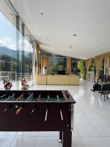 a pool table in the middle of a room at Villa Kaca 88 in Cinengangirang +66 photos