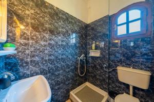a bathroom with a sink and a toilet and a window at Nana's House Holidays Greece in Dragotiná