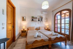 a bedroom with a bed with two pillows on it at Nana's House Holidays Greece in Dragotiná