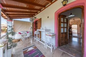 a room with a door and a table and chairs at Nana's House Holidays Greece in Dragotiná