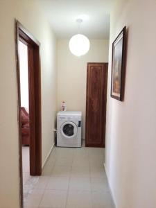 a hallway with a washing machine in a room at Bora's Apartment, Golem Beach in Golem