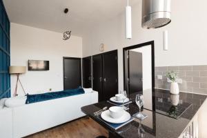 a living room with a couch and a table at Stylish Town Centre Suite by Traboule Properties LTD in Warrington +11 photos