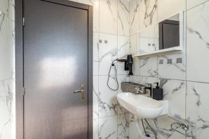 a bathroom with a sink and a door at Relaxrooms in Lefkímmi +36 photos